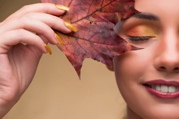 Woman with leaf who will get a chemical peel in the fall