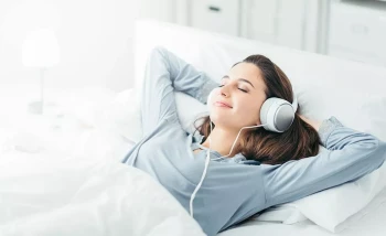 A woman listens to relaxing sounds while she sleeps