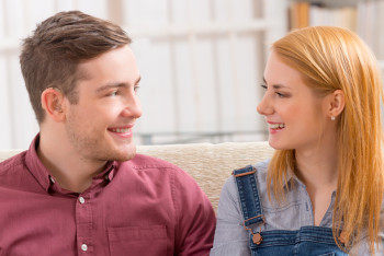 Young couple, man wears hearing aids