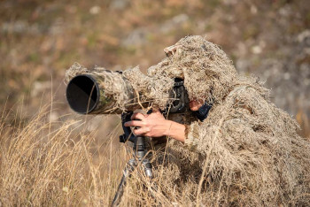 A cameraman wearing camouflage