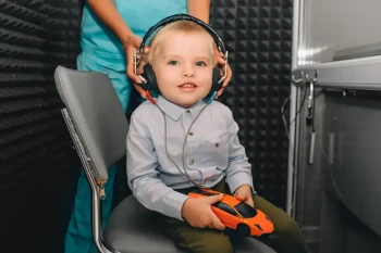 Child with hearing loss receiving a pediatric hearing test