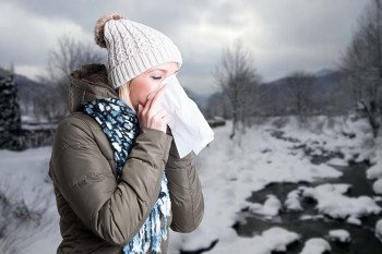 A sick woman in cold weather.