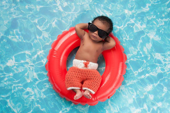 A baby wears sunglasses.