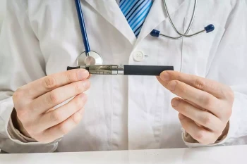 A doctor holds an e-cigarette