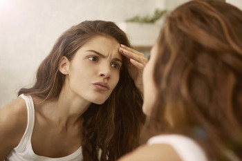 A woman contemplates plastic surgery.