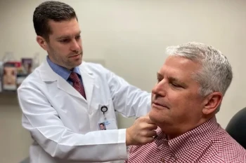 Dr. Nicholas Abt checking a patient's thyroids for thyroid nodules