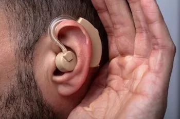 Man receiving hearing aid in his ear