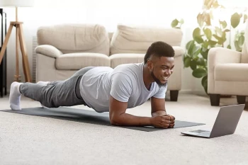 A man does healthy, in-home exercises