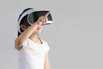 A little girl wears VR goggles