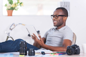 A man wearing glasses watches CEENTA's Five on Friday