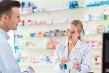 A man talks to a pharmacist about his medicine