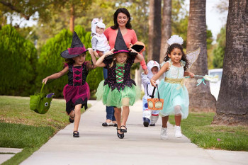 A mother and daughters go trick-or-treating