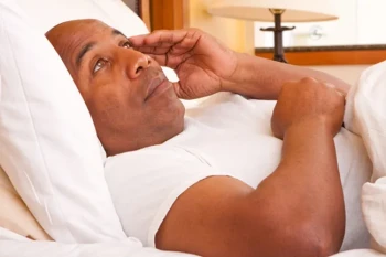 Man suffering from nasal congestion and lack of sleep