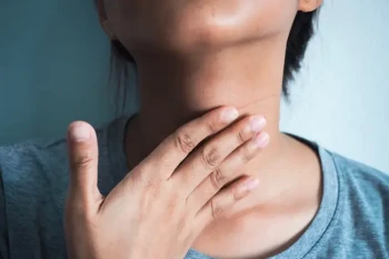 A woman treats her sore throat and the pain on the right side of her neck
