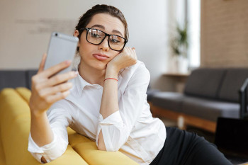 A woman is unhappy with the way she looks in her selfie.