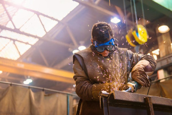 A man wears goggles to keep his eyes safe at work.
