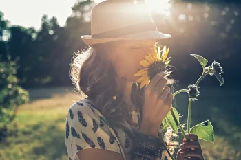 Woman smelling flower in the summer without a sinus infection