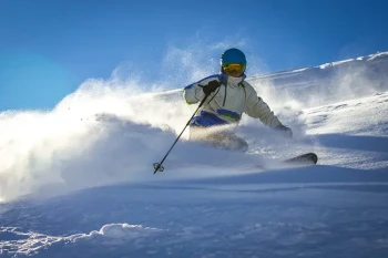 Man skiing and protecting eyes