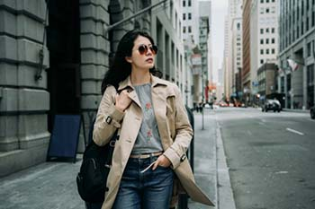 A woman wearing sunglasses on a cloudy day to protect her eyes