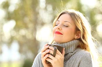 Woman breathing outside without nasal obstruction from allergies, sinusitis, or a deviated septum