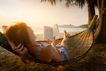 A woman reads on the beach
