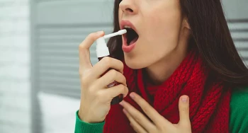 A woman treats her sore throat