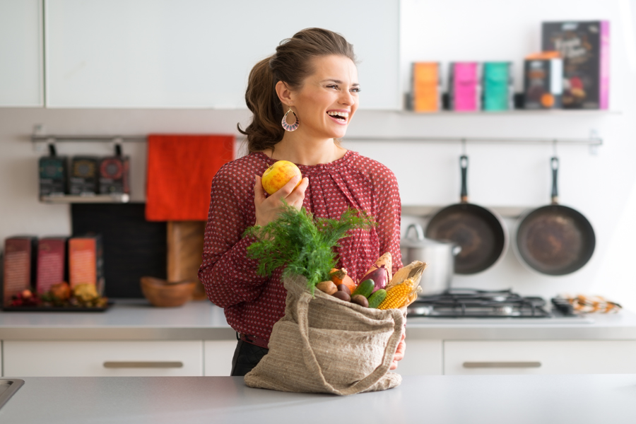 A woman purchases fresh fruits and vegetables