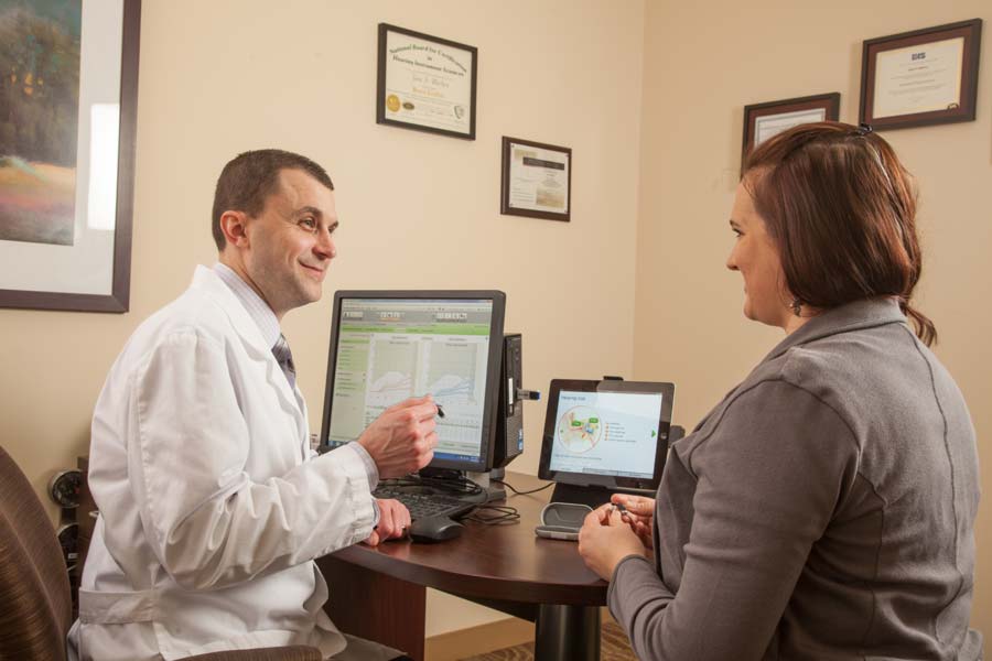 Audiologist discussing hearing aids vs. OTC hearing aids with patient