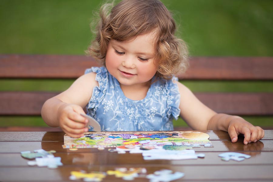 A child plays with a puzzle while improving her hand-eye coordination