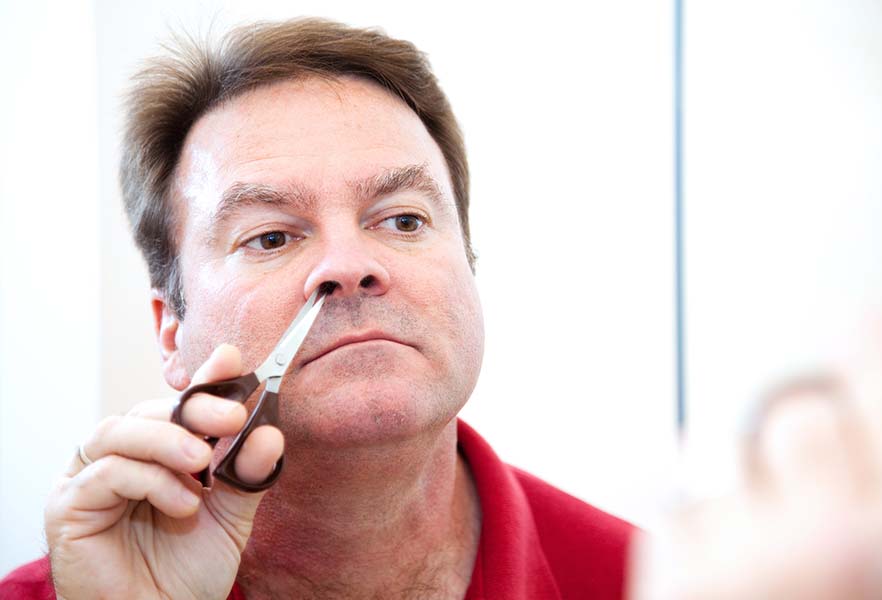 Trimming nose hair.