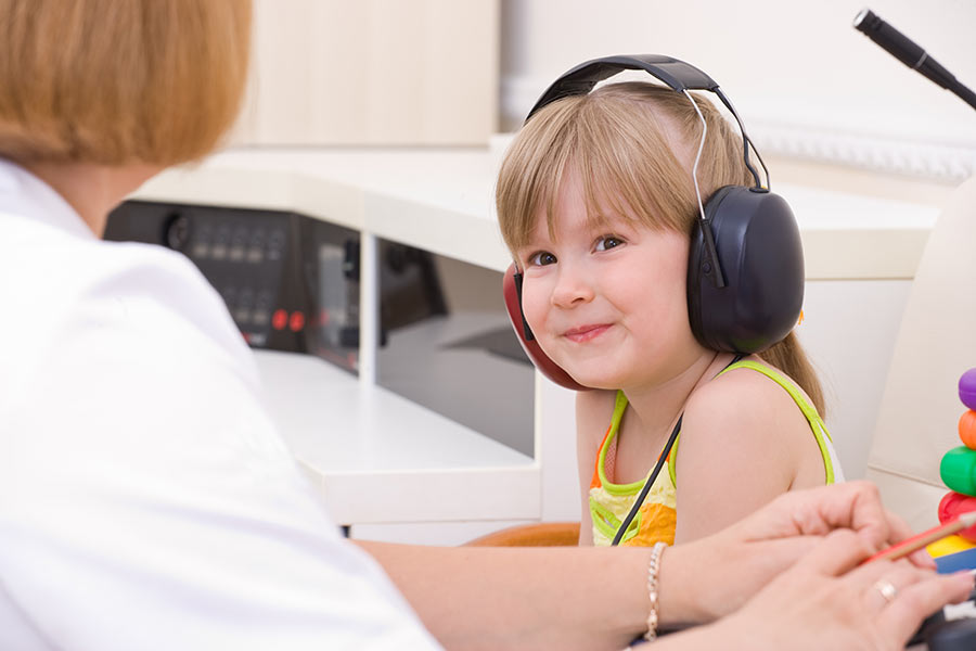 Child receiving pediatric hearing care, including a pediatric hearing test