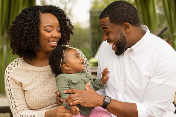 A baby talks with her family