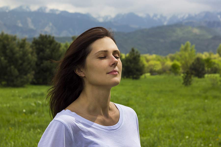 A woman breathes easily after treating her allergies.