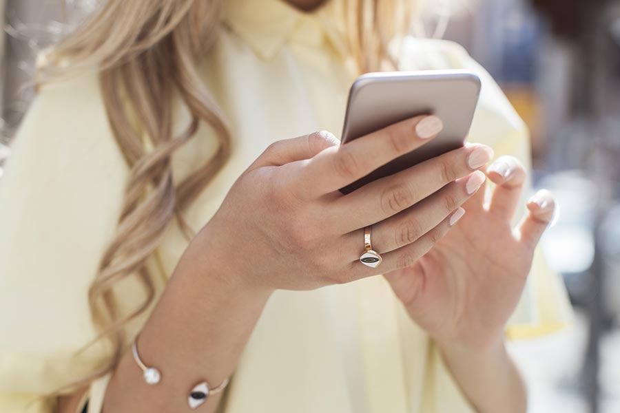 A woman checks myCEENTAchart on her phone