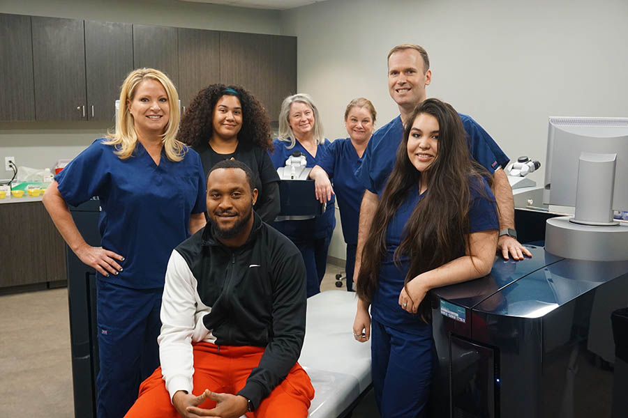 Jarius Wright before his LASIK surgery, with the staff and surgeon.